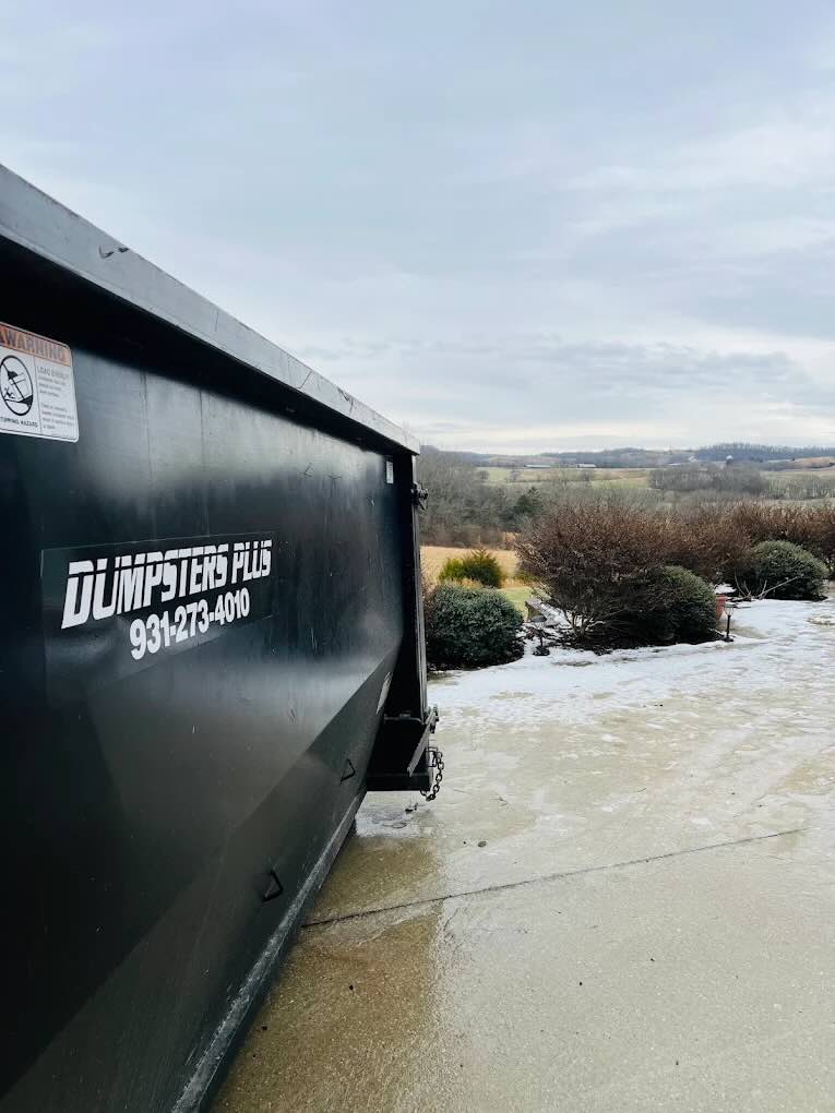 Dumpsters Plus roll off dumpster in a rural Middle Tennessee driveway for a local cleanup project